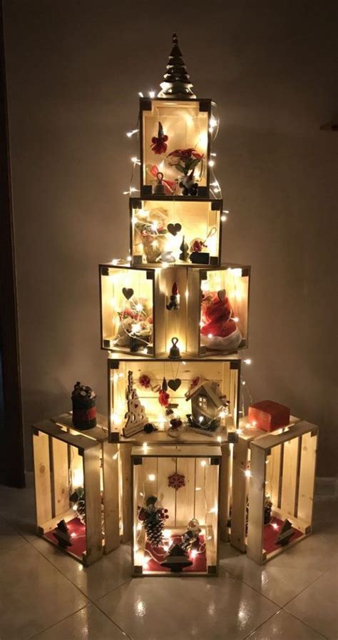 A Christmas Tree Made Out Of Wooden Crates With Lights On It And