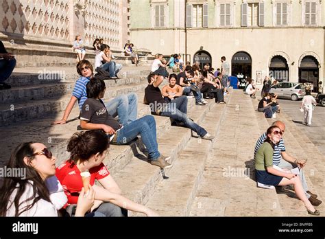 Young People Sitting On Steps Of Cathedral In Perugia Italy Stock
