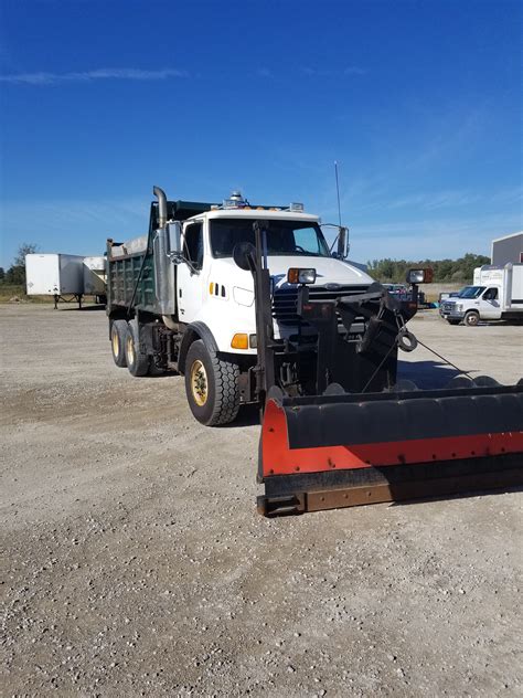 Tipper truck set on white background. 2003 STERLING LT9500 TANDEM DUMP TRUCK WITH SNOW PLOW AND WING - Oxford Mobile Fleet Service Inc.