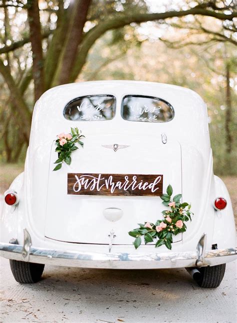 Just Married Sign And Delicate Florals On Vintage Wedding Getaway Car