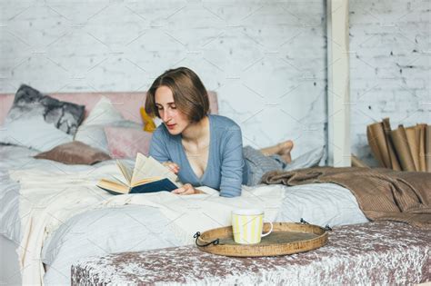 Young Woman Reading Book On Bed High Quality People Images Creative