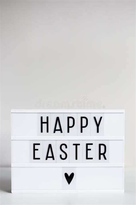 vintage lightbox with happy easter greetings on the table and copy space over wall stock image