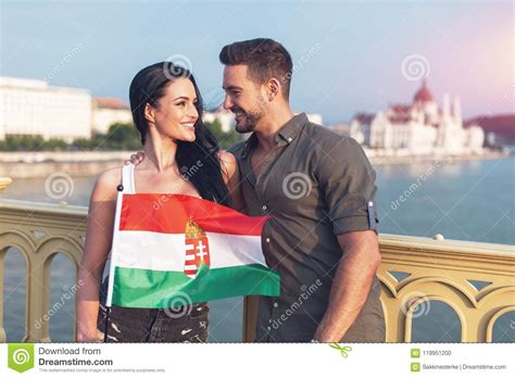 Happy Young Couple With Hungarian Flag Looking To Each Other Stock