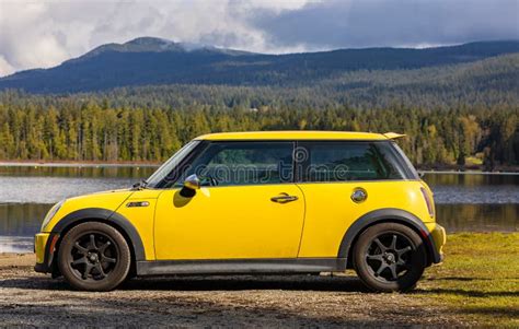 Side View Of A Yellow Mini Cooper S Car On Natural Background Yellow