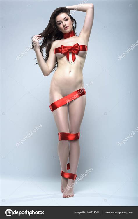 Beautiful Naked Woman Wrapped With Red Gift Ribbon Posing Isolated On