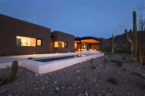 In design terms, painting a building in a light color specially the roofs could help keeping the temperatures at bay during the day, when the sun heat is problematic. Fascinating rammed earth home piercing the deserts of Arizona