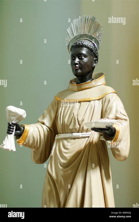Statue With Image Of St Benedict On Altar Decorated With Flowers Ofm