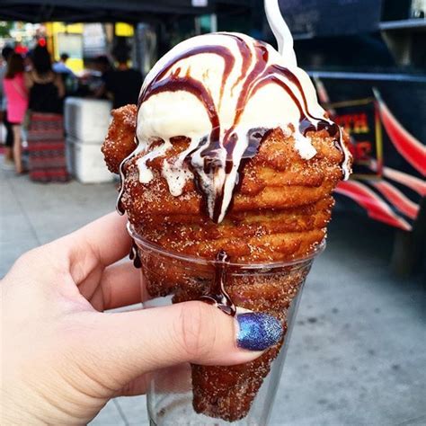 Churro Cone With Vanilla Ice Cream And Topped Off With Some Chocolate Sauce Drizzle From