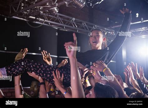 Crowd Surfing At A Concert In Nightclub Stock Photo Alamy