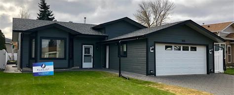 Pacific blue siding with black windows. Canexel Siding Renovation — Blue Jay Exterior Renovations