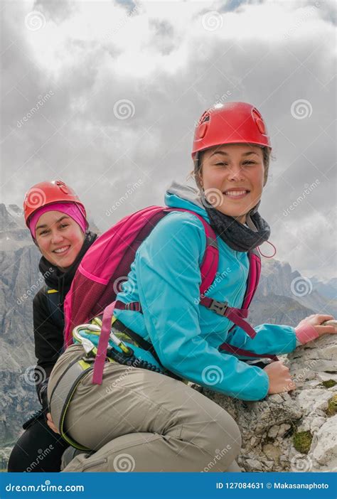Two Beautiful Young Female Mountain Climbers Smiling And Mountain