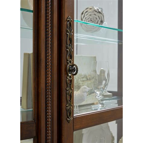 This petite cabinet will create a lovely accent in your home. Pulaski Foxcroft Curved End Curio Cabinet - 102003