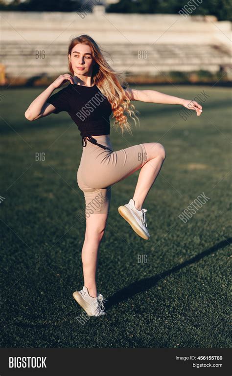 girl raises her knees image and photo free trial bigstock