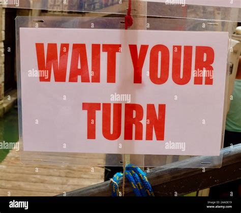 Wait Your Turn Sign In Red Lettering Stock Photo Alamy