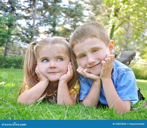Happy Children Smiling In Green Grass Stock Photo Image Of Little