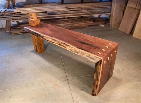 A Wooden Bench Sitting On Top Of A Cement Floor Next To Wood Planks In