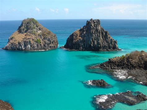 Aerial Photography Of Cliffs Surrounded By Body Of Water Fernando De