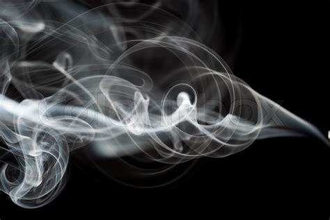 Abstract Black Smoke Swirls Over The Black Background