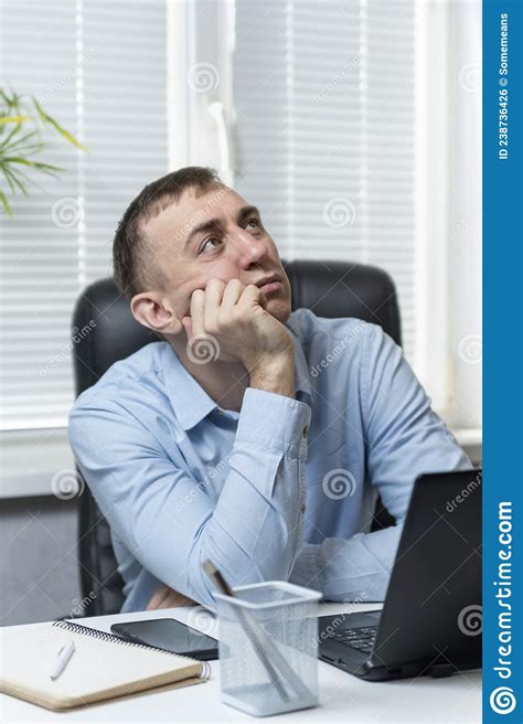 Brooding Young Man In The Office Behind The Workplace Portrait Of An