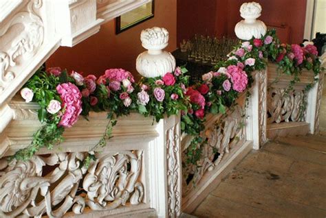 Decorating just the handrails of your home's magnificent staircase with this pretty staircase decor idea done with a simple red carpet, dracaena plants and candles along the corners is oozing with grace. Stair garland by Floraldeco | Staircase decor, Stairway ...