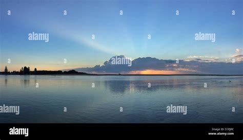 Sunrise Over A Lake With Reflection Of The Blue Sky Stock Photo Alamy