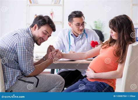 The Pregnant Woman With Her Husband Visiting The Doctor In Clinic Stock Image Image Of Exam