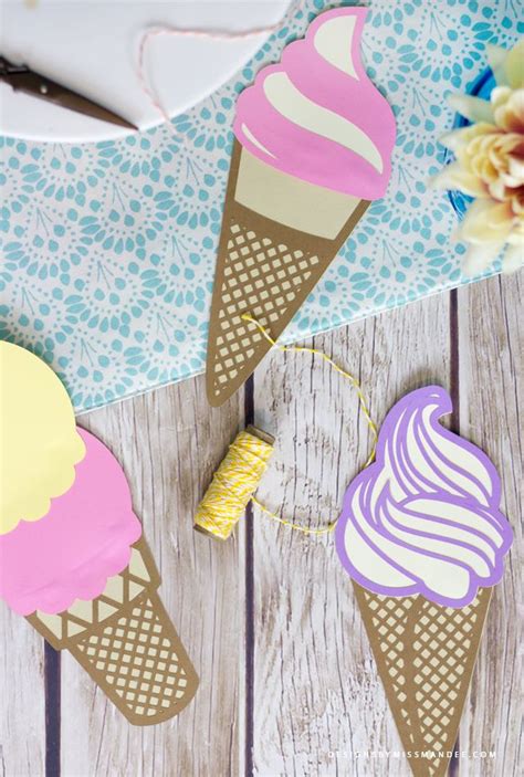 Three Ice Cream Cones Are Sitting On A Wooden Table With Flowers And