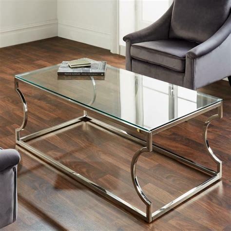The trapezoid shape of the product has a unique look. MODERN SILVER STAINLESS STEEL METAL CLEAR GLASS TOP COFFEE TABLE WITH CURVE LEGS - All Home Living