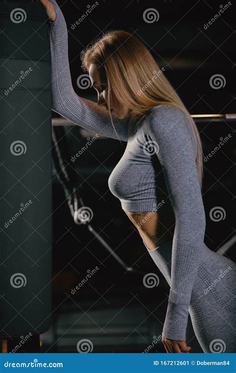 Beautiful Fitness Blonde Woman Is Standing Near Training Apparatus And Posing Stock Image