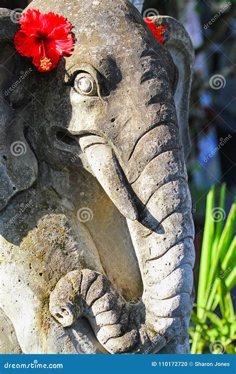 Hindu Religious Elephant Sculpture With Red Hibiscus Flowers Bali
