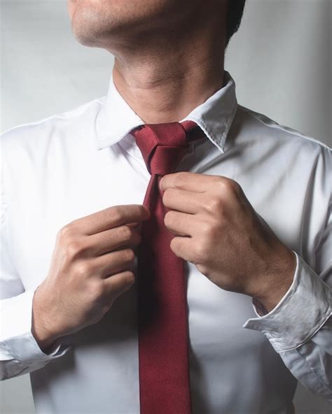 Premium Photo A Red Tie With A Trinity Knot Being Wore By A Man In