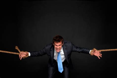 Businessman Being Pulled By Rope On Both Sides Stock Photo Download