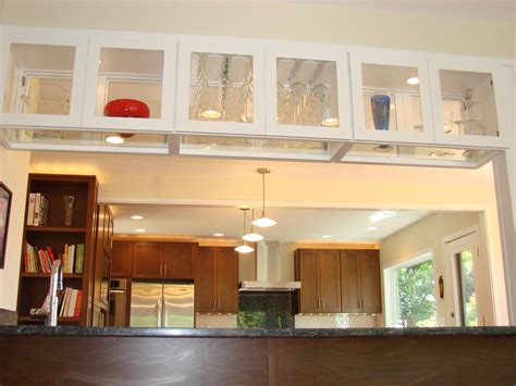 As a helper steadies the assembly, check the cabinet face with a level to see if it's plumb. short double sided glass kitchen cabinets - Google Search ...