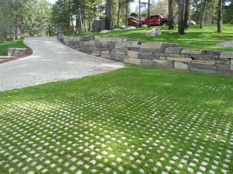 Paver Driveway With Grass Grid Pavers And Boulder Wall Constructed Of