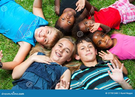 Diverse Group Og Children Laying Together On Grass Royalty Free Stock