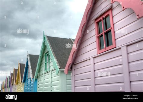 Mersea Essex Row Of Brightly Coloured Traditional Beach Hut Stock