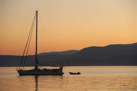 A Boat On Calm Sea During Sunset · Free Stock Photo