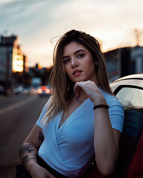 Close Up Photo Of Woman Leaning On Vehicle Posing · Free Stock Photo