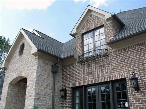 A dramatic transformation of the front elevation due to expanding the front entry, removing the roof soffits, replacing all windows and doors, adding gas lanterns, installing faux copper gutters, replacing the roof, and revamping the hardscape. Top 50 Best Brick And Stone Exterior Ideas - Cladding Designs