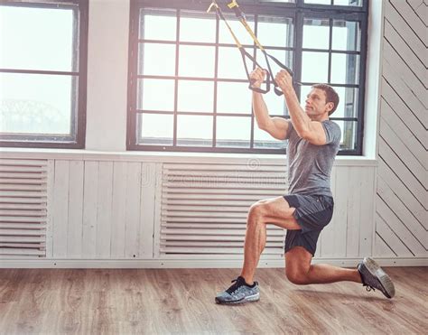 Muscular Fitness Male Doing Exercise With Trx Functional Workout At