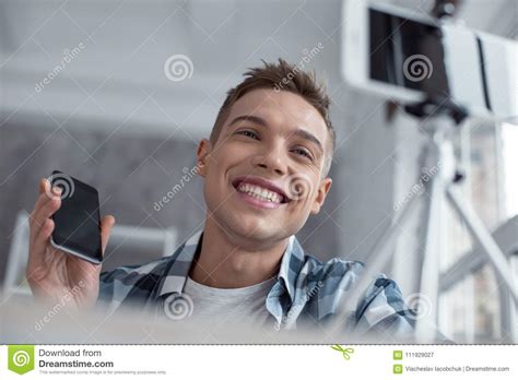 exuberant blogger talking about his new phone on cam stock image image of device freelancing
