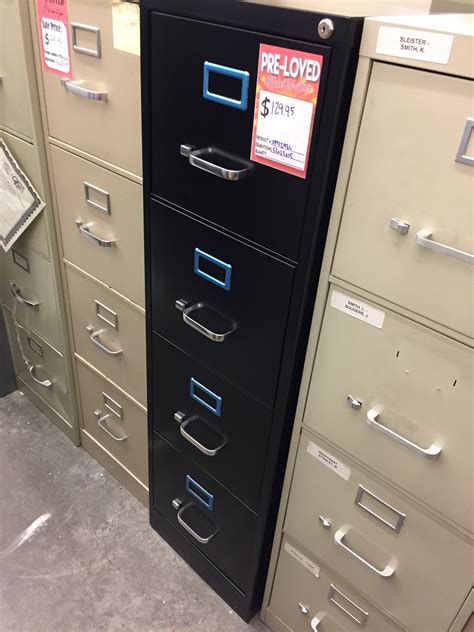 While many feature protruding handles on the drawer faces, recessed handles are not uncommon. Used Four Drawer Black Metal Vertical Filing Cabinet