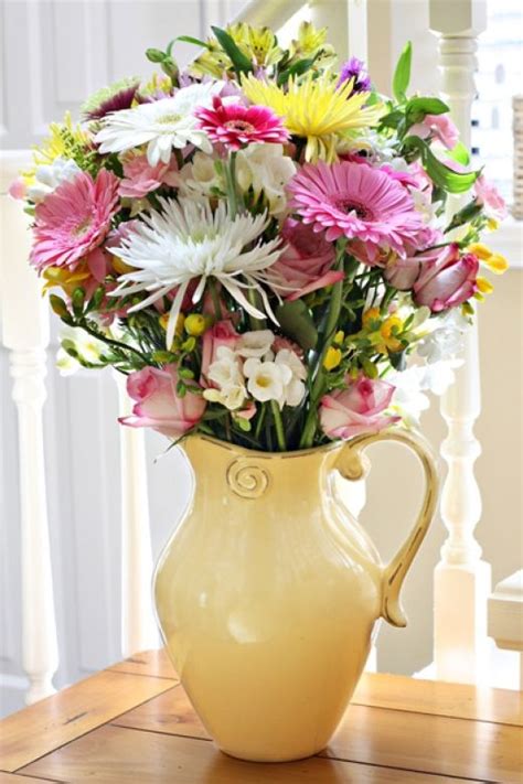A rustic french pottery pitcher from the 19th century, with white floral décor, and brown and green glaze. Pitcher Of Fresh Cut Flowers Pictures, Photos, and Images ...