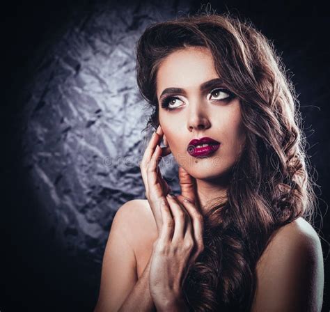 Glamorous Young Woman With Evening Makeup Touching Her Face Stock
