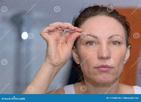 Woman Plucking Her Eyebrows With Tweezers Stock Photo Image Of Brow Face