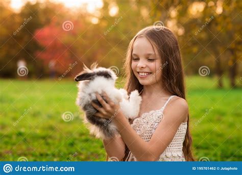 Happy Little Child Girl With Cute Rabbit Portrait Of Kid