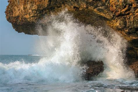A Splashing Big Wave Crashing Into The Rocks Stock Photo Image Of
