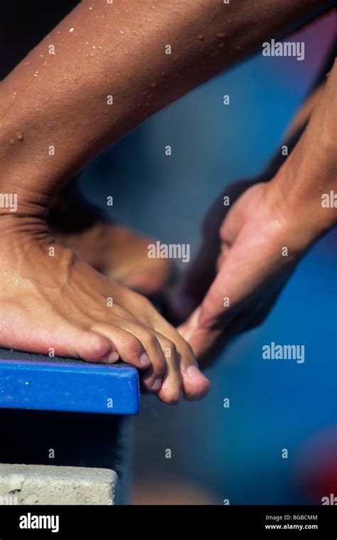 Swimmers Feet And Hands On The Edge Of A Diving Board Stock Photo Alamy