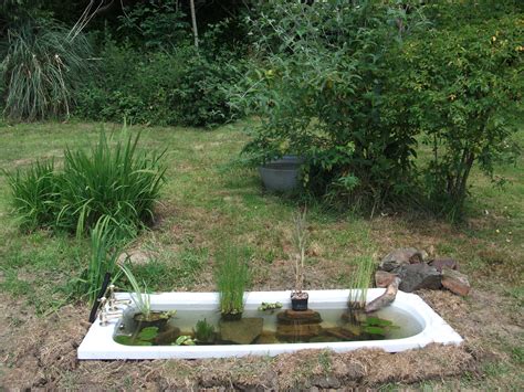 This garden fountain may look substantial and difficult, but all it is is a large pot set in the garden, with a simple bubbler placed inside. Made my old bath into a pond! | Dream garden | Pinterest ...