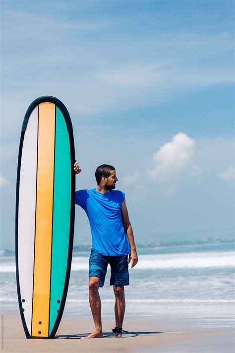 Young Surfer Standing Next To A Longboard At A Surfing Beach Del